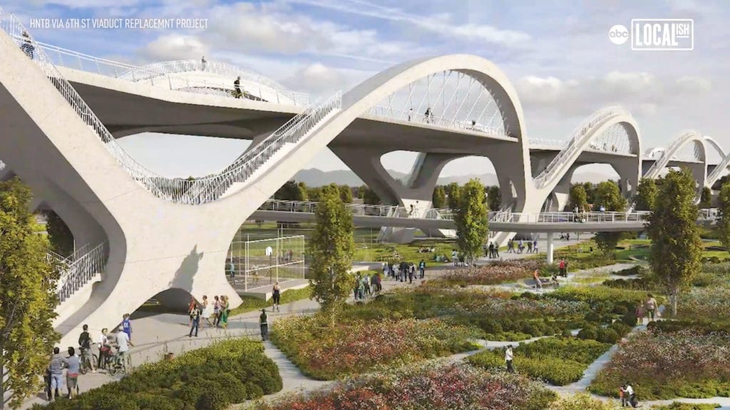 People walking under the ribbon of light bridge in Los Angeles.