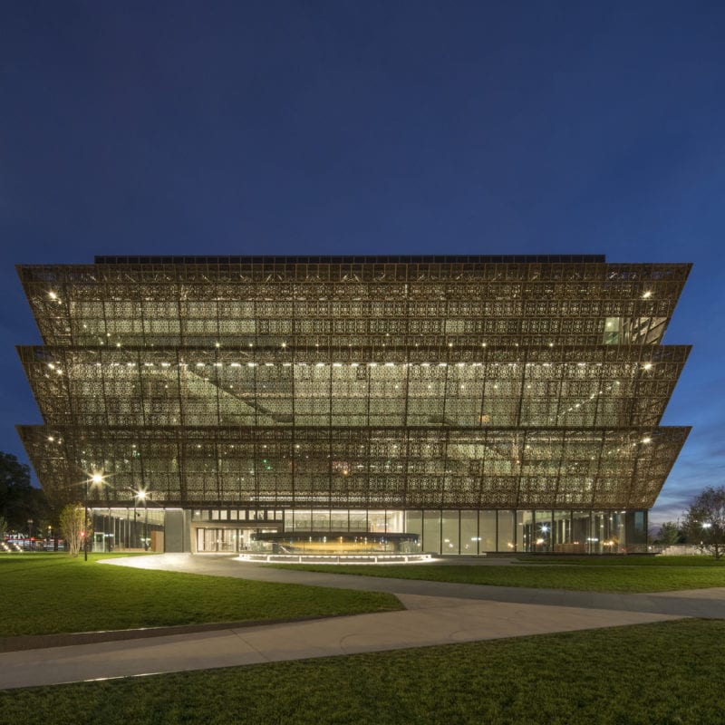 The Smithsonian National Museum of African American History and Culture located in Washington DC, USA at night time.